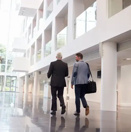 Businessmen walking through office lobby aura